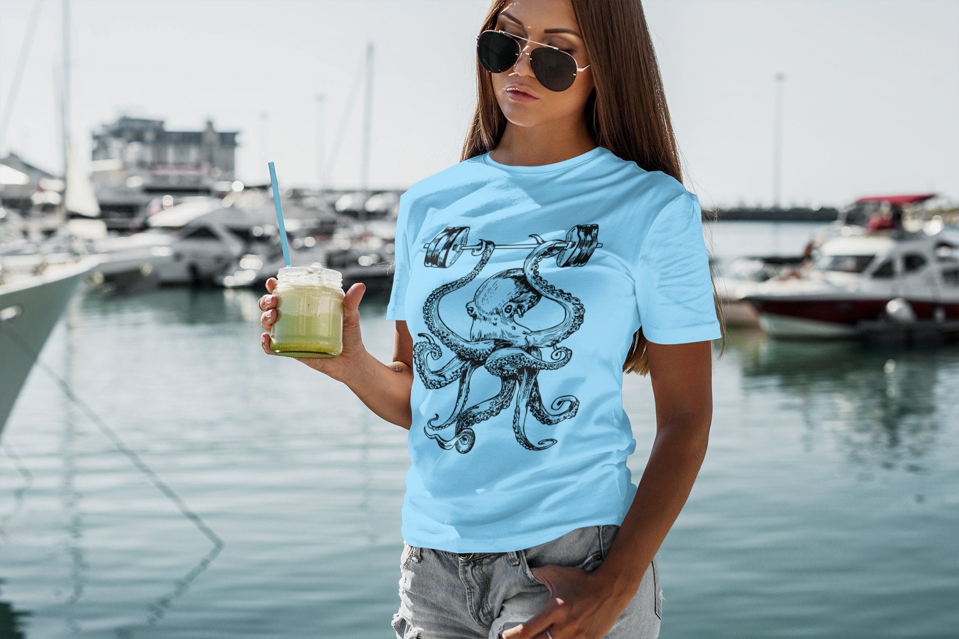 seembo-octopus-workout-lifting-barbells-light-blue-t-shirt-of-a-woman-drinking-a-smoothie-ipe204