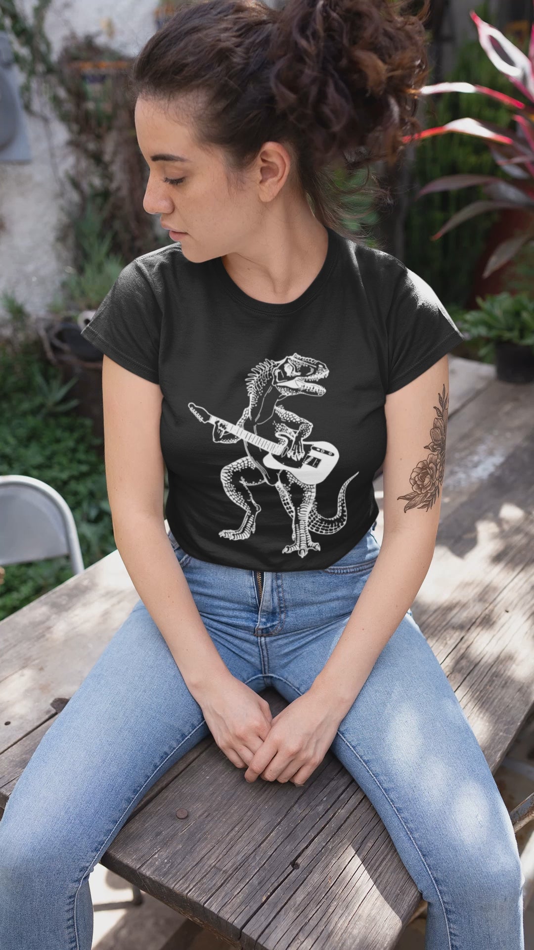 seembo-dinosaur-playing-guitar-guitarist-musician-music-band-black-t-shirt-woman-sitting-on-a-wooden-table