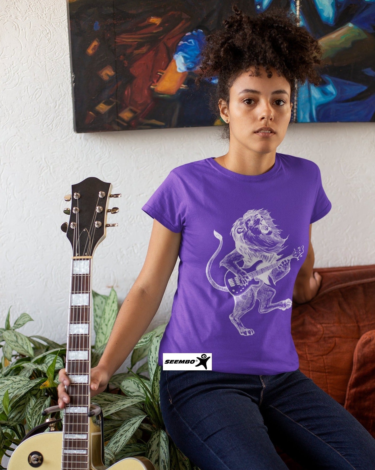 seembo-lion-playing-guitar-guitarist-purple-t-shirt-of-a-woman-posing-with-her-guitar