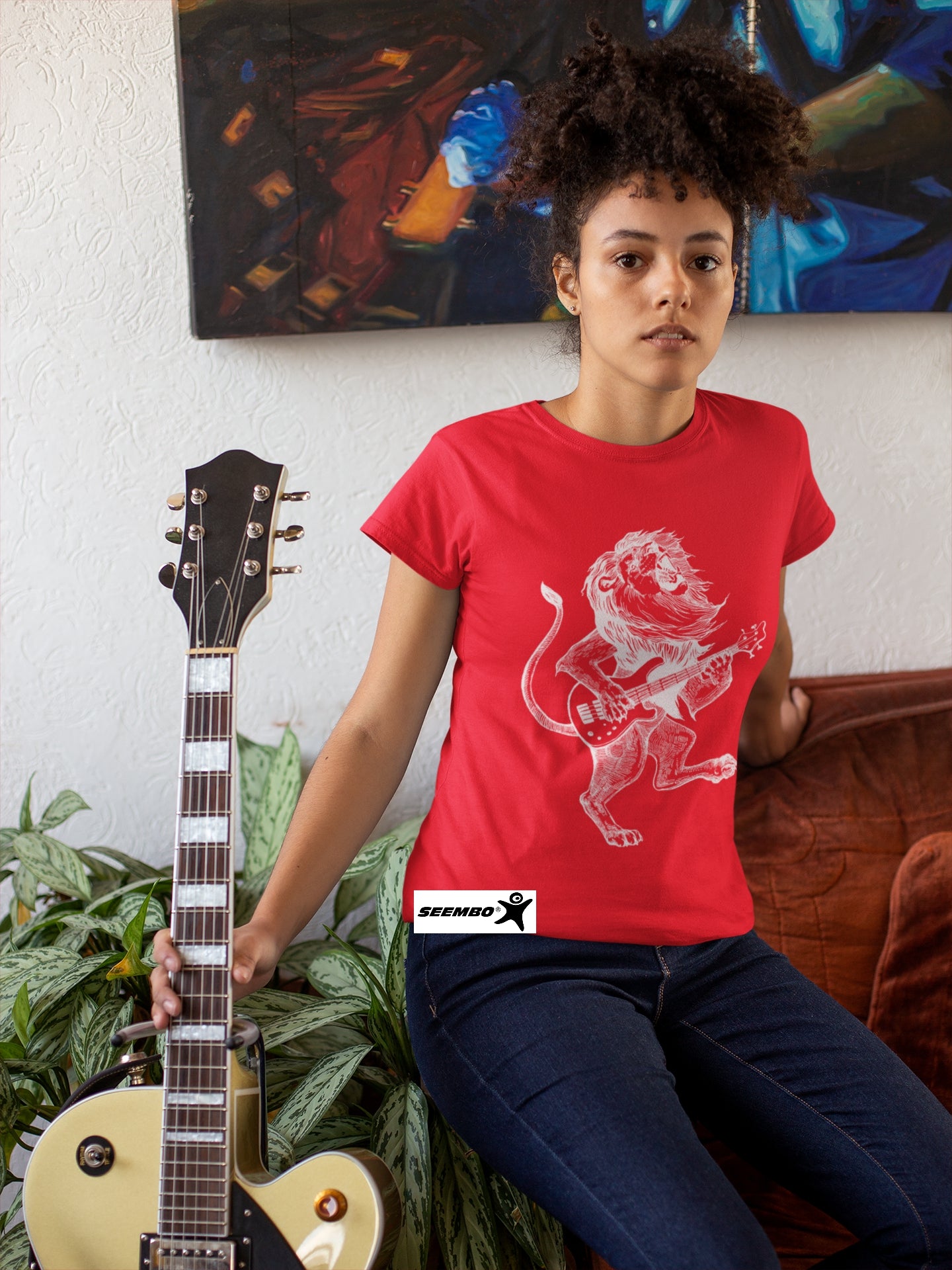 seembo-lion-playing-guitar-guitarist-misician-red-t-shirt-of-a-woman-posing-with-her-guitar